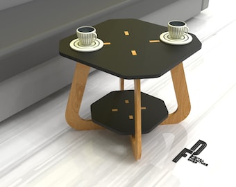 May include: A black hexagonal side table with two shelves and a wood frame. The table has a modern design with gold accents. Two white cups and saucers are on the top shelf.