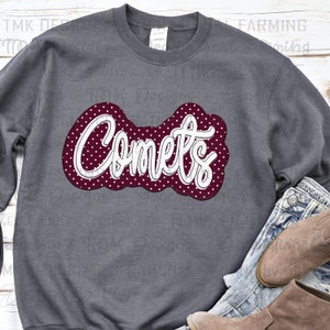 May include: A dark gray sweatshirt with a maroon and white design that says "Comets" in a white cursive font. The design has white polka dots on a maroon background.