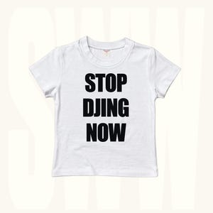 White baby tee with bold STOP DJING NOW slogan print