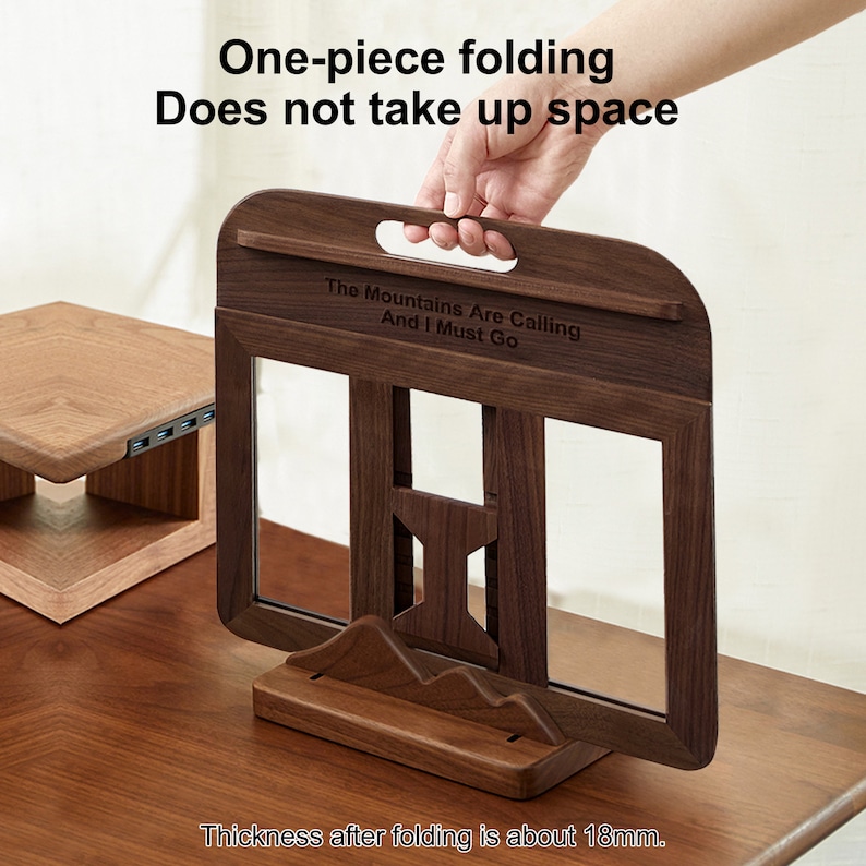 May include: A wooden book stand with a quote engraved on the front: "The Mountains Are Calling And I Must Go". The stand is folded and has a handle on the top. The stand is 18 mm thick when folded.