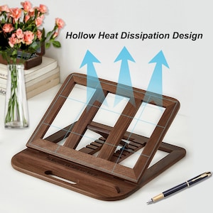 May include: A wooden book stand with a hollow design for heat dissipation. The stand is angled to hold a book or tablet at a comfortable reading position. The stand has a handle and a quote engraved on the base: "The Mountains Are Calling And I Must Go."