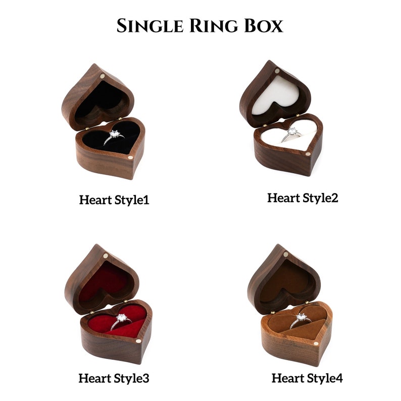 May include: Four different styles of wooden heart-shaped ring boxes. Each box is open and has a ring inside. The boxes are made of dark wood and have a velvet interior. The ring boxes are labeled "Heart Style 1", "Heart Style 2", "Heart Style 3", and "Heart Style 4".