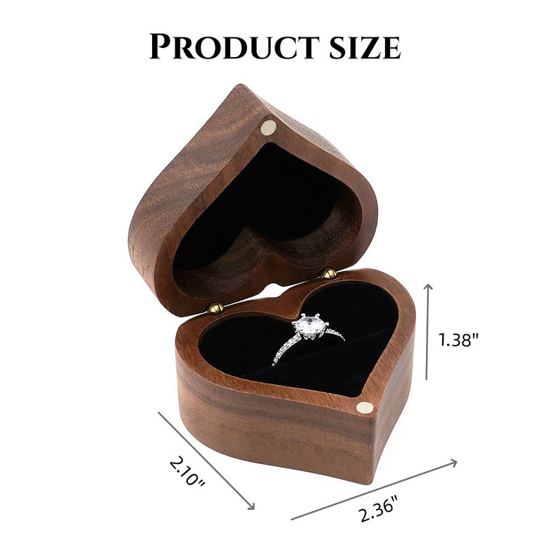 May include: A heart-shaped wooden ring box with a black velvet interior. The box measures 2.10 inches wide, 2.36 inches long, and 1.38 inches high.
