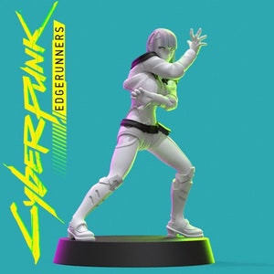 May include: White 3D printed figurine of a female character from the Cyberpunk: Edgerunners anime series. The character is posed in a fighting stance with her arms raised and her legs spread apart. The figurine is standing on a black circular base.