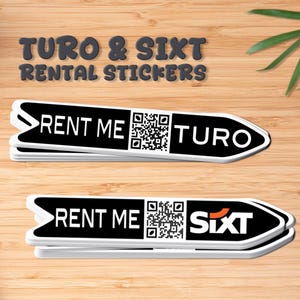 May include: Black and white arrow-shaped rental stickers with the text "RENT ME" and QR codes. One sticker says "TURO" and the other says "SIXT". The stickers are on a wooden surface, with a coffee cup, notepad, and pen.