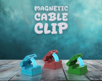 May include: The image displays three magnetic cable clips in blue, red, and green. Each clip holds a cable with a glowing blue light. The text "MAGNETIC CABLE CLIP" is at the top of the image.