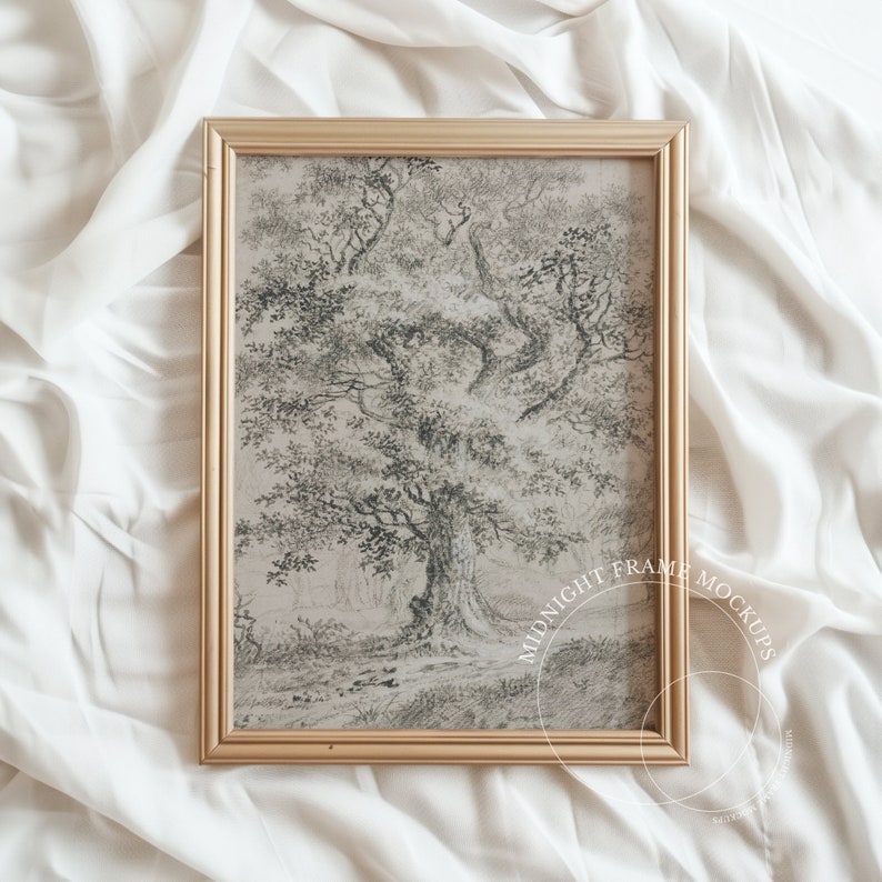 May include: A framed monochrome print depicting a large tree with intricate leaves. The artwork is encased in a gold-coloured rectangular frame. The background is a white, textured fabric.