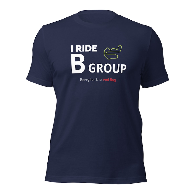 May include: A navy blue t-shirt with white text that reads "I ride B group" and a green track outline. The text "Sorry for the red flag" is written in white with the word "red" in red.