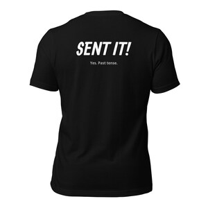 May include: Black t-shirt with white text that reads "SENT IT!" and "Yes. Past tense."