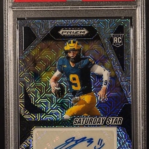 May include: A graded sports trading card featuring JJ McCarthy in a blue and yellow uniform. The card is a 2024 Prizm Draft Picks Saturday Star Sig-Mojo, with a signature and the text "CHASER!!" at the bottom.