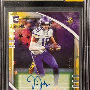 May include: A graded Justin Jefferson rookie card from the 2020 Absolute Signature Rookies Gold Stars series. The card features an image of Jefferson in his Vikings uniform, an autograph, and the text "CHASER!!". The card is graded 9.5 by Beckett.