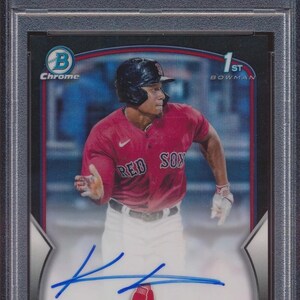 May include: A 2023 Bowman Draft baseball card featuring Kristian Campbell in a Red Sox uniform. The card is graded Mint 9 by PSA and includes an autograph. The card's text includes "Chrome Prospect AU-BLK REF" and "shortstop."