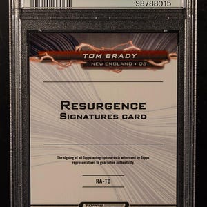 May include: A Tom Brady "Resurgence Signatures Card" in a protective case. The card features the player's name, team, and position. The card is from the Topps Composite series and is authenticated by PSA.