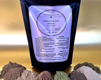 May include: A black pouch of Elevated Haircare Strengthening Herbal Hairmask, 10 oz, with application instructions and benefits printed on the label. Surrounding the base are several small piles of various colored herbal powders in shades of brown, green, and grey.