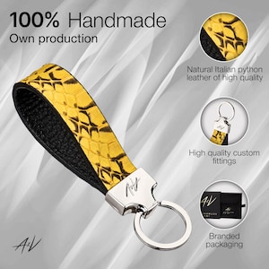 May include: A yellow and black leather keyring with a silver ring and a silver logo that says "A/V Handmade". The keyring is made of natural Italian python leather and has high quality custom fittings. The keyring comes in branded packaging.