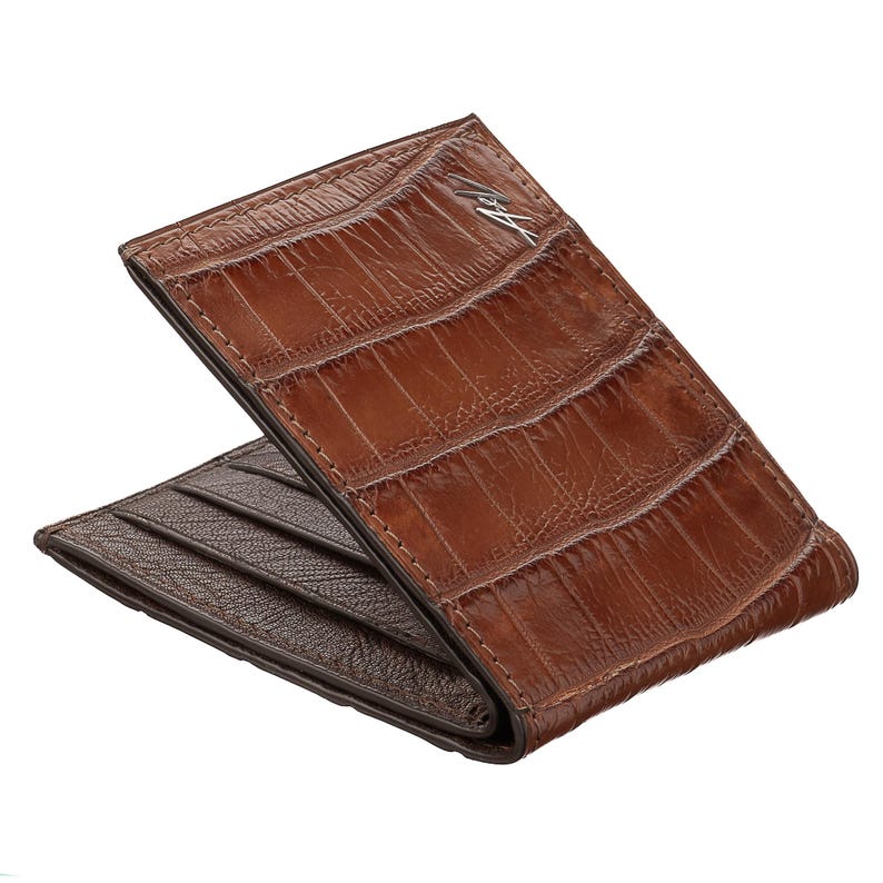 May include: A brown leather wallet with a crocodile pattern. The wallet is folded in half and has a silver logo on the front.