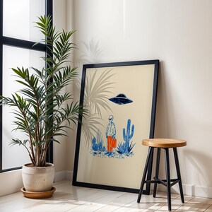 Retro alien UFO wall art featuring a quirky extraterrestrial walking through a desert landscape with cactus plants under a hovering spaceship. Bold blue and orange accents add a playful modern touch to the minimalist sci-fi illustration. Perfect for game rooms, living rooms, or offices, this unique artwork brings humor, character, and a creative sci-fi vibe to any interior. Ideal for space lovers and geek decor.