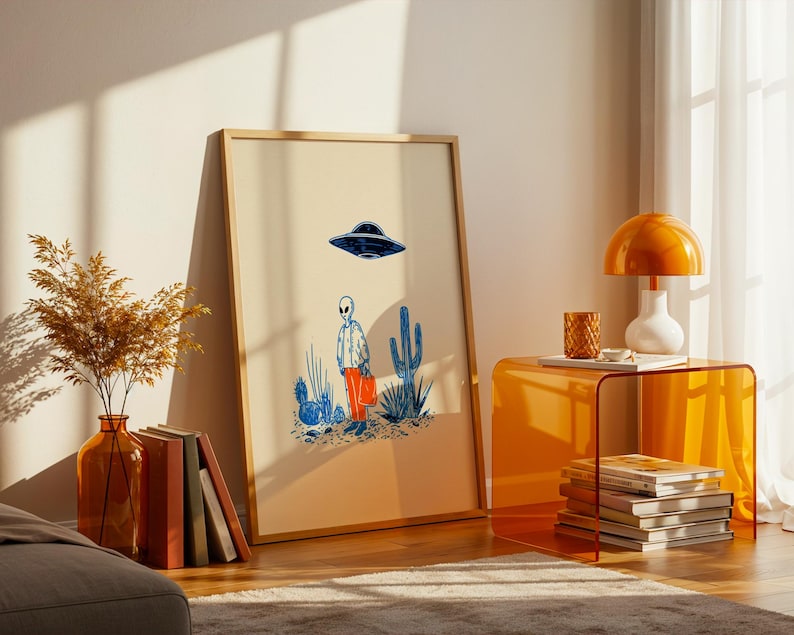 Retro alien UFO wall art featuring a quirky extraterrestrial walking through a desert landscape with cactus plants under a hovering spaceship. Bold blue and orange accents add a playful modern touch to the minimalist sci-fi illustration. Perfect for game rooms, living rooms, or offices, this unique artwork brings humor, character, and a creative sci-fi vibe to any interior. Ideal for space lovers and geek decor.