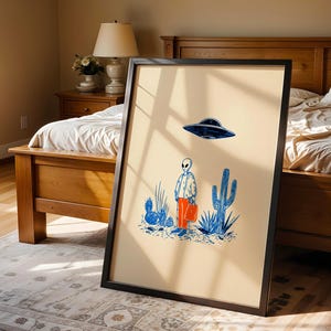 Retro alien UFO wall art featuring a quirky extraterrestrial walking through a desert landscape with cactus plants under a hovering spaceship. Bold blue and orange accents add a playful modern touch to the minimalist sci-fi illustration. Perfect for game rooms, living rooms, or offices, this unique artwork brings humor, character, and a creative sci-fi vibe to any interior. Ideal for space lovers and geek decor.