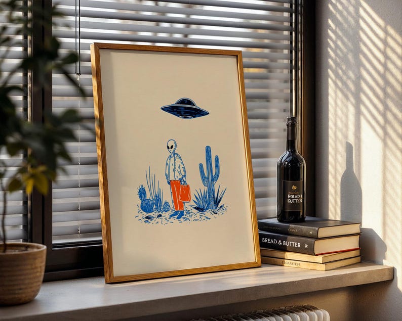 Retro alien UFO wall art featuring a quirky extraterrestrial walking through a desert landscape with cactus plants under a hovering spaceship. Bold blue and orange accents add a playful modern touch to the minimalist sci-fi illustration. Perfect for game rooms, living rooms, or offices, this unique artwork brings humor, character, and a creative sci-fi vibe to any interior. Ideal for space lovers and geek decor.