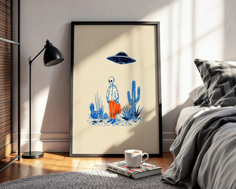 Retro alien UFO wall art featuring a quirky extraterrestrial walking through a desert landscape with cactus plants under a hovering spaceship. Bold blue and orange accents add a playful modern touch to the minimalist sci-fi illustration. Perfect for game rooms, living rooms, or offices, this unique artwork brings humor, character, and a creative sci-fi vibe to any interior. Ideal for space lovers and geek decor.