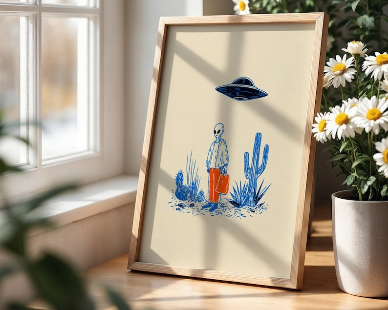 Retro alien UFO wall art featuring a quirky extraterrestrial walking through a desert landscape with cactus plants under a hovering spaceship. Bold blue and orange accents add a playful modern touch to the minimalist sci-fi illustration. Perfect for game rooms, living rooms, or offices, this unique artwork brings humor, character, and a creative sci-fi vibe to any interior. Ideal for space lovers and geek decor.