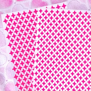 May include: Two sheets of pink star stickers on a white background. The stars are arranged in a repeating pattern.
