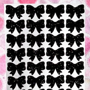 May include: A sheet of black glitter bow stickers. There are 36 bows in total.