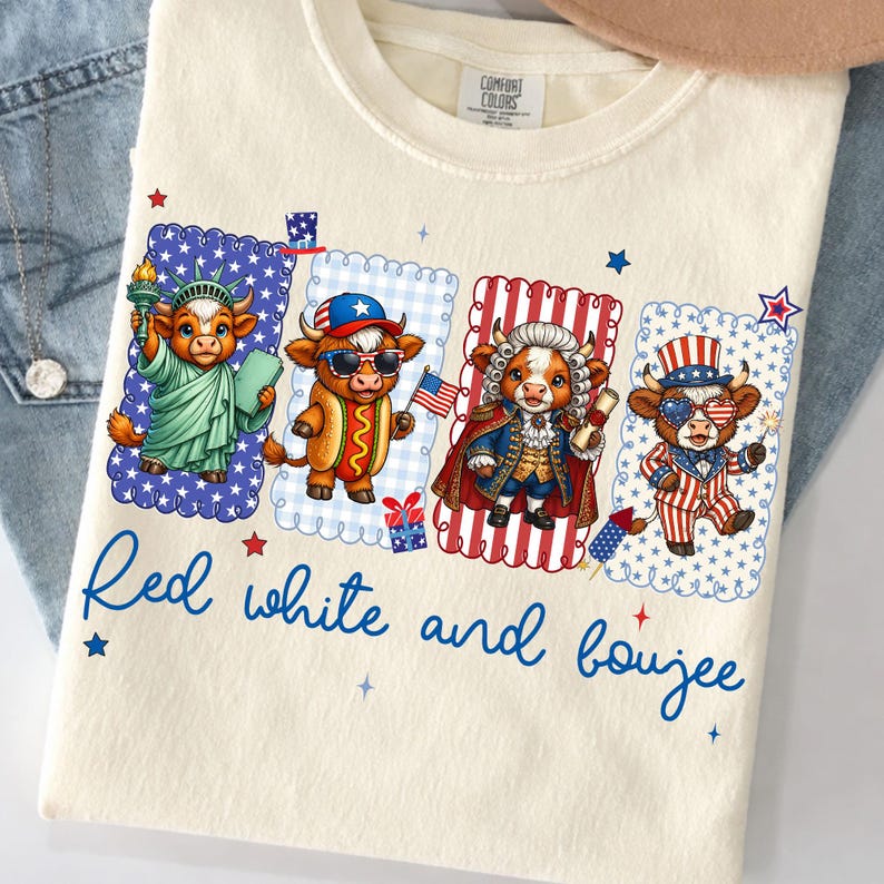 May include: Cream-colored t-shirt featuring four cartoon cows dressed in patriotic attire. Each cow is in a different frame with a unique design. The text "Red white and boujee" is written in blue script across the bottom.