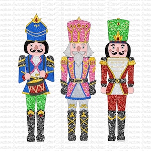 May include: Three glitter-covered nutcracker figurines. The nutcracker on the left is wearing a blue hat, blue and green uniform, and is holding a red drum. The nutcracker in the middle is wearing a pink hat, pink and blue uniform, and has a white beard. The nutcracker on the right is wearing a green hat, red and gold uniform, and has a black mustache.