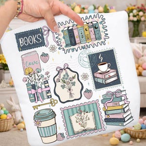 May include: White cushion featuring a book-themed design with stamps, books, flowers, and coffee. The design includes the word "BOOKS". The cushion has a whimsical, vintage aesthetic.