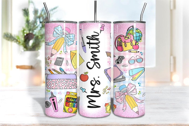 May include: A pink glitter tumbler with a teacher theme. The tumbler features school supplies like pencils, pens, and a backpack. The name "Mrs. Smith" is written on the tumbler.