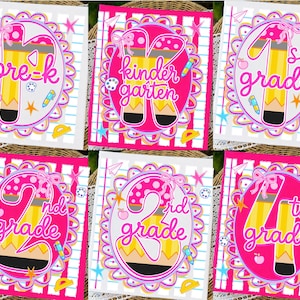 May include: A set of six rectangular school-themed graphic prints featuring pink oval frames with scalloped edges. Each print displays a grade level from pre-k to 4th grade, stylized with yellow pencil motifs, pink bows, apples, and school supplies.