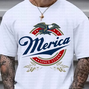 May include: White t-shirt with a vintage-style logo featuring an eagle, the word "Merica", and the text "Since 1776".