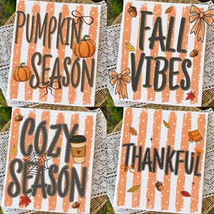 May include: Four rectangular signs with orange and white vertical stripes. The signs feature dark brown text reading Pumpkin Season, Fall Vibes, Cozy Season, and Thankful, decorated with illustrations of pumpkins, bows, acorns, leaves, and a coffee cup.