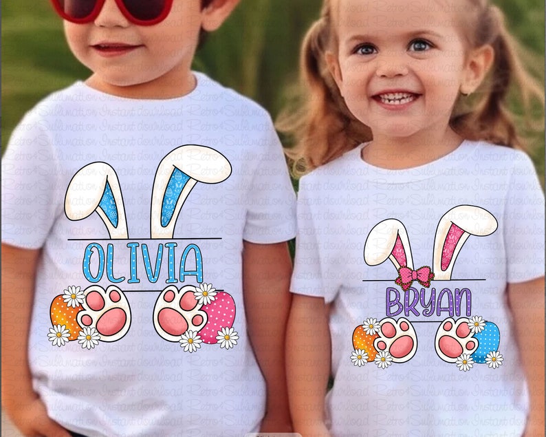 May include: Two white t-shirts with bunny ears and Easter egg designs. The shirts have the names "Olivia" and "Bryan" printed on them.
