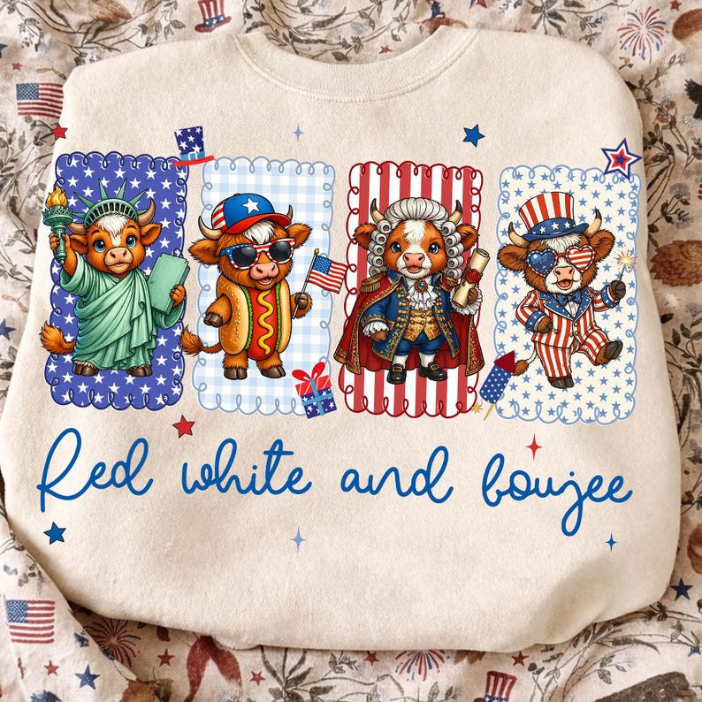 May include: A cream-colored sweatshirt featuring four cartoon cows dressed in patriotic attire. The cows are in rectangular frames with scalloped edges. The text "Red white and boujee" is written in blue script across the bottom.
