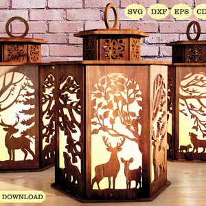 May include: Three wooden lanterns with intricate cutouts of trees, deer, and other woodland creatures. The lanterns are illuminated from within, creating a warm glow. The text "DIGITAL DOWNLOAD" is visible at the bottom of the image.
