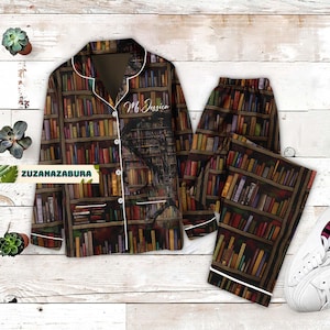 May include: A brown and white pyjama set with a bookshelf print. The top has a white trim and a button fastening. The text "Ms. Jessica" is printed on the top.