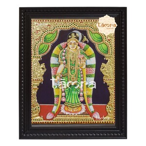 May include: A framed painting of a Hindu goddess with a green and gold sari, holding a lotus flower. The painting is on a dark blue background with gold accents. The frame is black with gold accents.