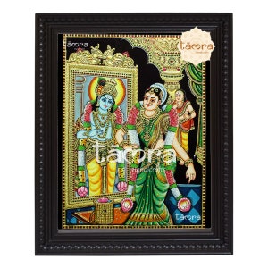 May include: A traditional Indian painting depicting a couple in a colorful setting. The painting is framed in a black wooden frame with gold accents. The painting is titled "tåora handicrafts".
