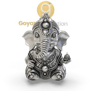 May include: A silver-colored statue of the Hindu deity Ganesha, depicted in a seated position. The statue features intricate details, including a crown, jewelry, and a small bell held in one hand. The text "Goyar Creation" is visible.