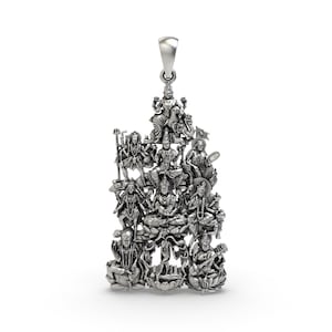 May include: A silver pendant featuring detailed depictions of multiple deities. The pendant has a bail at the top for a chain and showcases intricate carvings of various figures in seated and standing poses, with ornate details.
