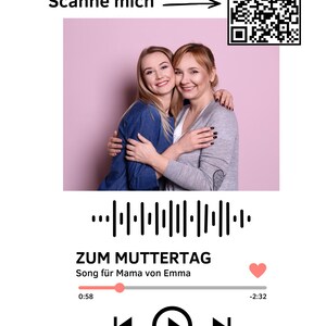 May include: Image featuring two smiling women embracing, set against a pink backdrop. The image includes a QR code and text that reads "Scan me." Below the photo is a music player interface with the text "ZUM MUTTERTAG" and "Song für Mama von Emma."