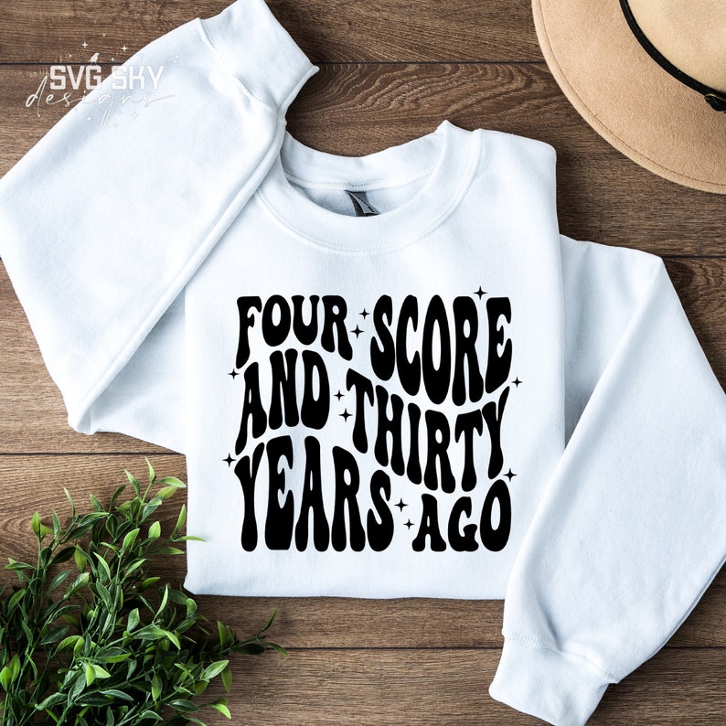 May include: White sweatshirt with black text that reads "Four Score and Thirty Years Ago" in a retro font.