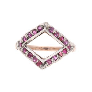 May include: A vintage ring with a geometric design. The ring features a diamond-shaped center with a border of small, round, pink gemstones. The band is a light gold color, and the setting is silver.