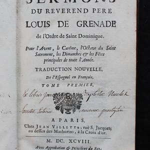 May include: An open book page with black text. The title reads "SERMONS" above the name "LOUIS DE GRENADE." Additional text describes the book's contents and publisher. The page has a floral illustration and handwritten notes.