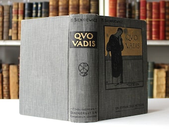 Puede incluir: Un libro de tapa dura gris con el título "Quo Vadis" en letras doradas. El libro es de Henryk Sienkiewicz y está publicado por Benziger & Co. SA en Einsiedeln, Suiza.