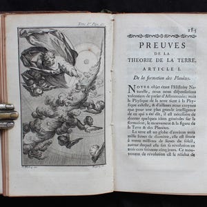 May include: An open antique book with detailed illustrations and French text. The left page features a celestial scene with figures and clouds, while the right page displays the title "PREUVES DE LA THEORIE DE LA TERRE."