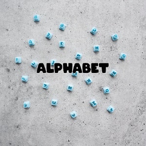 May include: Blue alphabet letter tiles scattered on a grey background with the word "ALPHABET" spelled out in black letters.